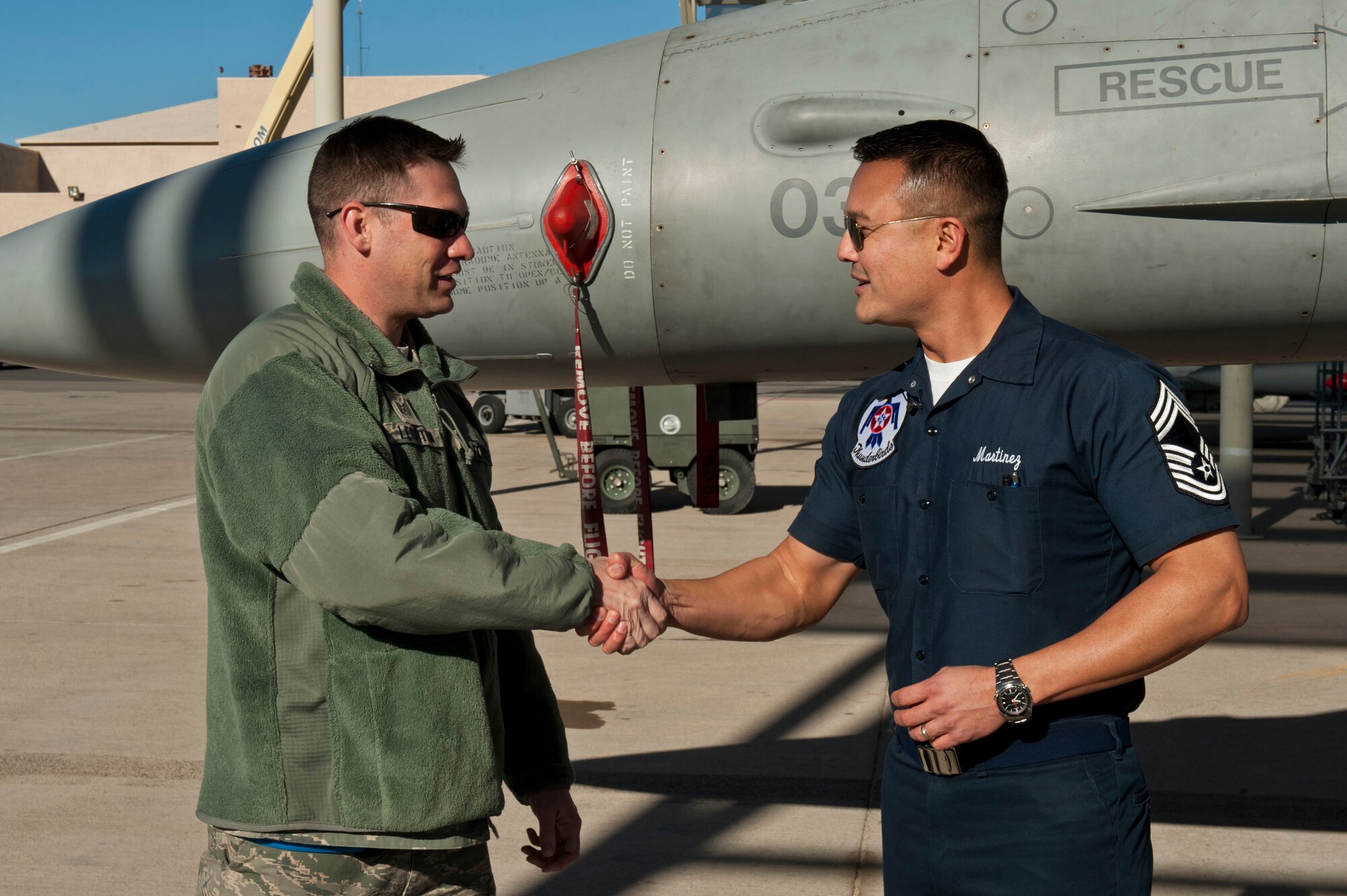 U.S. Air Force Chief Master Sgt. Michael Martinez, Air Force Aerial Demonstration Squadron, Thunderbirds, congratulates Tech. Sgt. Jason Leighton, 52nd Maintenance Operations Squadron weapons inspector, on being selected to join the Thunderbirds team Jan. 18, 2013, at Nellis Air Force Base, Nev. Leighton came to Nellis from Spangdahlem Air Base, Germany, to participate in RED FLAG 13-2. (U.S. Air Force photo by Senior Airman Daniel Hughes)