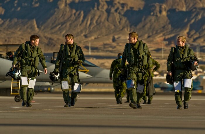 NELLIS AIR FORCE BASE, Nev. – Pilots from Sweden’s 172nd Fighter Reconnaissance Squadron walk away from their JAS-39 Gripen fighter jets after landing at Nellis Air Force Base, Nev., to participate in RED FLAG 13-2 Jan. 17, 2013. The exercise is hosted north of Las Vegas on the Nevada Test and Training Range, which has more than 12,000 square miles of airspace and 2.9 million acres of land; with 1,900 possible targets, realistic threat systems and an opposing enemy force that cannot be replicated anywhere else in the world. (U.S. Air Force photo by Senior Airman Daniel Hughes)