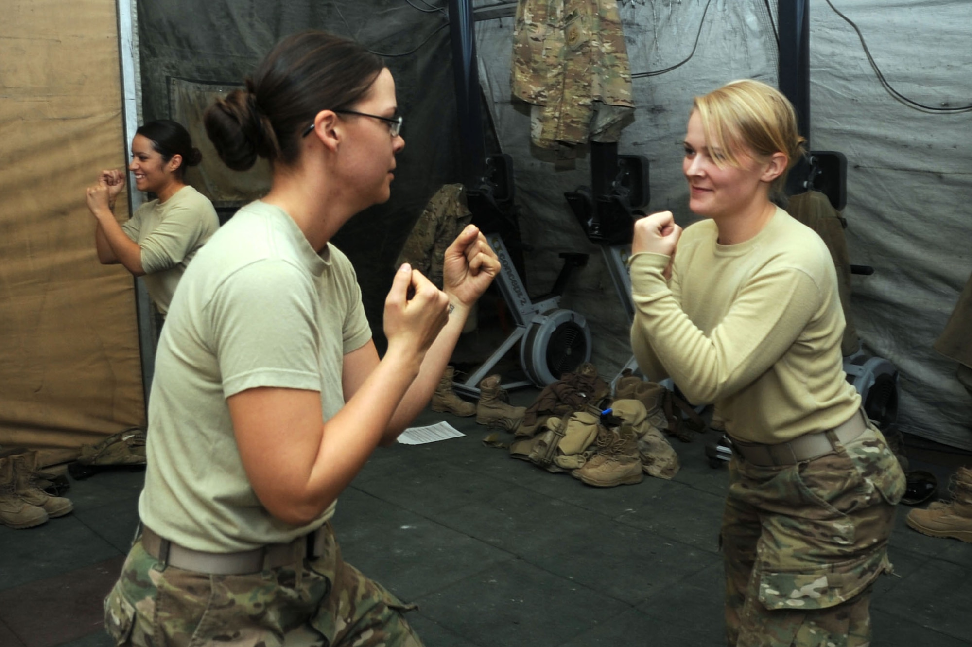 Staff Sgt. Callie Lewis, 455th Expeditionary Communications Squadron C4 project manager (left), and Airman 1st Class Megan Wendland, 4th Expeditionary Reconnaissance Squadron aviation resource manager, practice the proper fighting stance during a self-defense course on Bagram Airfield, Afghanistan, Jan. 20, 2013. The course is designed to bolster Airmen's combat skills and is the first such course in Air Forces Central Command. (U.S. Air Force photo/Staff Sgt. David Dobrydney)