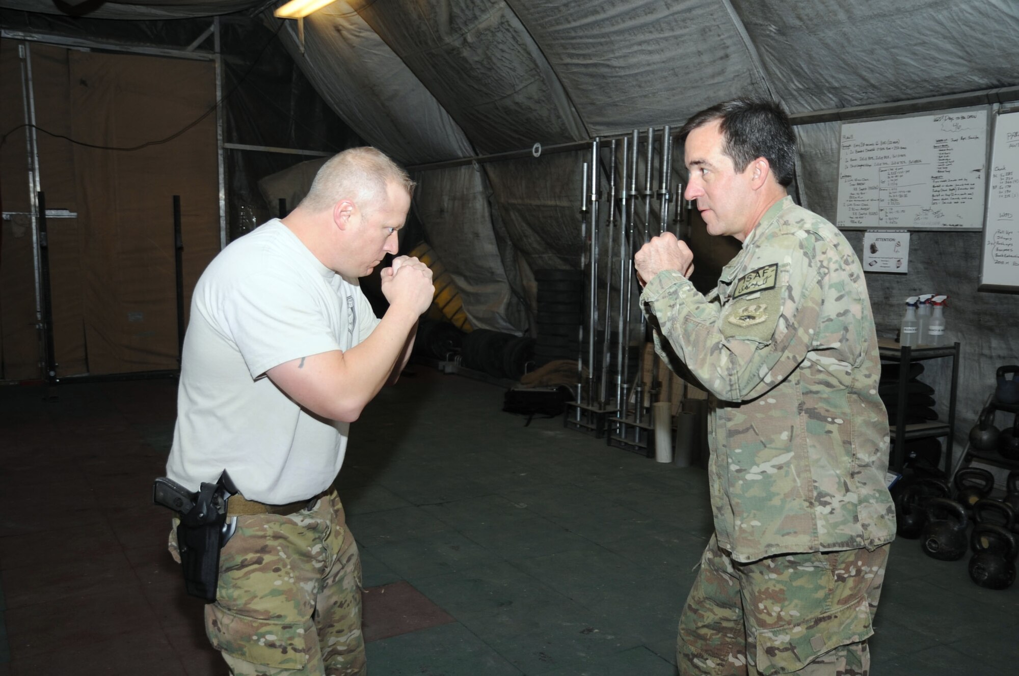 Master Sgt. Damian Larche, 455th Air Expeditionary Wing Check 6 instructor, demonstrates a proper fighting stance to 455th AEW Command Chief Master Sgt. Steven Bohannon during a self-defense course on Bagram Airfield, Jan. 20, 2013. The 455th AEW is currently the only wing in Air Forces Central Command to host such a course. (U.S. Air Force photo/Staff Sgt. David Dobrydney)