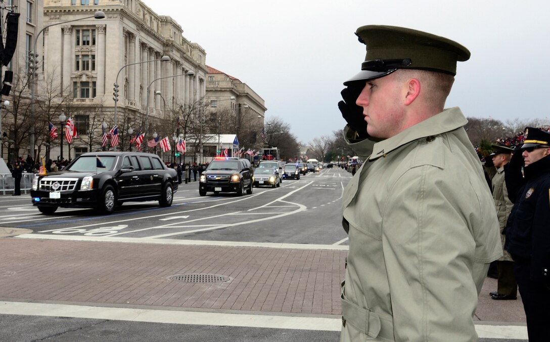 U.S. Marine Corps Private 1st Class Connor Brown renders honors as the presidential motorcade drives to the Capitol Building en route to the swearing-in ceremony at the U.S. Capitol in Washington, D.C., Jan. 21, 2013. More than 1,200 services members from all five branches of the military complete the cordon for the 57th Inauguration Day ceremony.