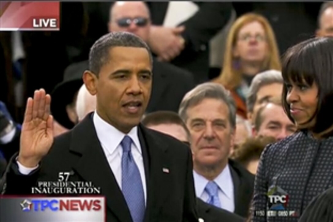 President Barack Obama takes the oath of office from Supreme Court Chief Justice John G. Roberts Jr. (at right, not shown) in a public ceremony at the U.S. Capitol before thousands of people in Washington, D.C., Jan. 21, 2013. Roberts administered the oath in an official ceremony at the White House, Jan., 20, 2013.