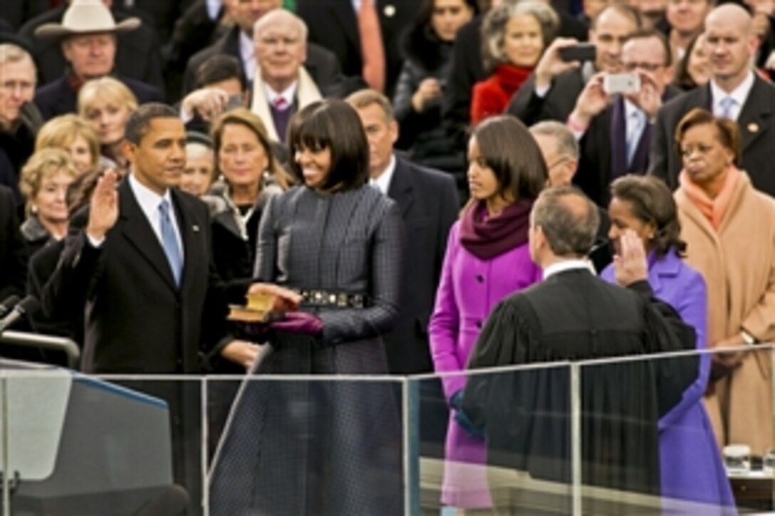 President Barack Obama takes the oath of office from Supreme Court Chief Justice John G. Roberts Jr., right, in a public ceremony at the U.S. Capitol before thousands of people in Washington, D.C., Jan. 21, 2013. Roberts administered the oath in an official ceremony at the White House, Jan. 20, 2013.