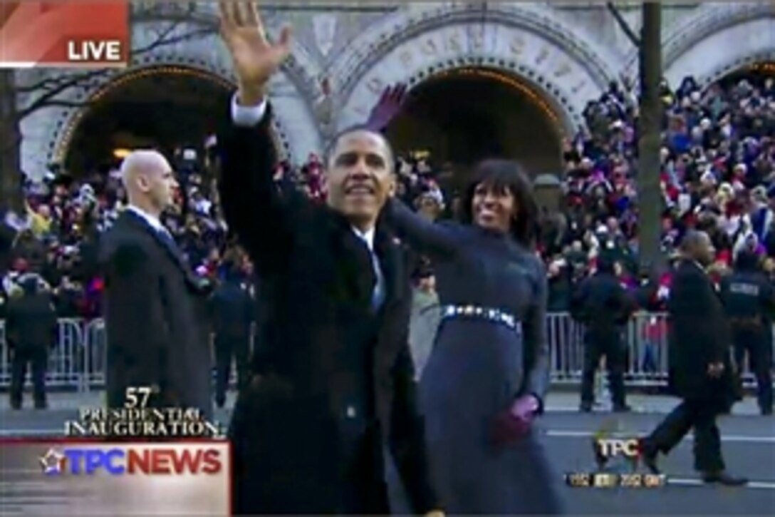 President Barack Obama and First Lady Michelle Obama walk and wave for a short time during the 57th Inaugural Day parade in Washington, D.C., Jan. 21, 2013.