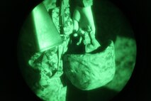 A Marine with 2nd Supply Battalion, 2nd Marine Logistics Group holds his helmet just prior to gearing up for a night convoy at Camp Lejeune’s Home Station Training Lanes in Holly Ridge, N.C., Jan. 16, 2013. The Marines relied on night vision equipment and directions from their command operations center to complete their 45-minute trip through dark gravel roads and city streets.