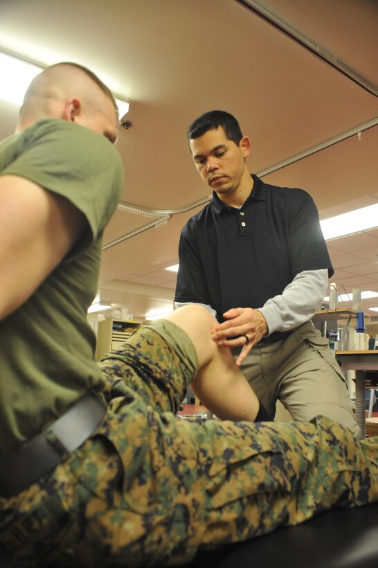 During a one-on-one session at Ramer Hall on Jan. 17., Edward J. Sedory, certified athletic trainer, The Basic School, tries to figure out the source of pain in a Marine’s leg. Sedory was recognized as the Virginia Athletic Trainers Association's 2012 Virginia Athletic Trainer of the Year in clinical and emerging practices on Jan. 12. 