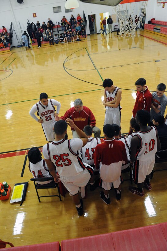 Ed Cottrell, head coach for the Quantico Middle/High School Boys Varsity Basketball Team, talks to the team after the first quarter during their game against the Chelsea Academy High at QMHS on Jan. 18. Both teams fought hard but the Warriors were victorious, 50-45.