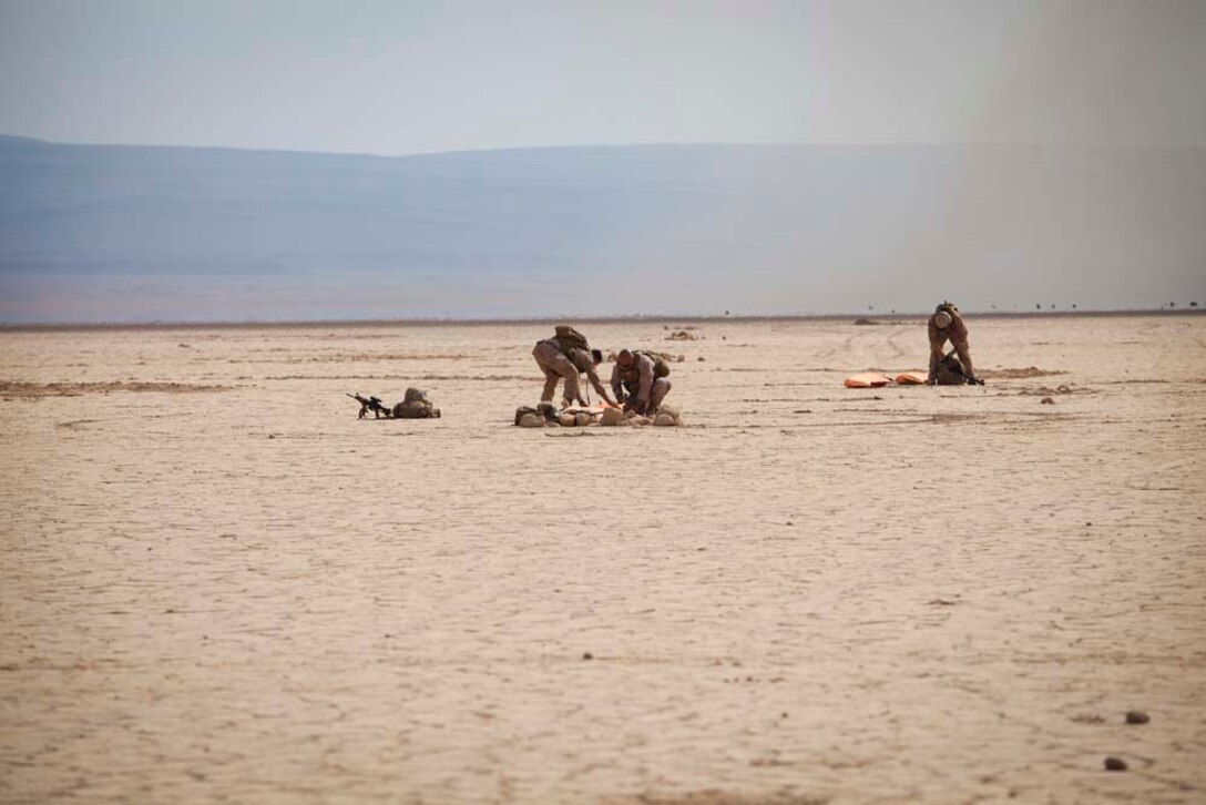Marines with Mobile Marine Air Traffic Control Team, Marine Medium Helicopter 364 (Rein.), 15th Marine Expeditionary Unit, place marker panels that designate the beginning of a runway during a Mobile Marine Air Traffic Control training evolution in Djibouti, Jan 4.   The mission for the MMT, or "pathfinders" as they're colloquially referred to, is to establish an assault landing zone (runway) and provide air traffic control for multiple aircraft as well as command and control during the entire refuel/resupply mission.  The 15th MEU is deployed as part of the Peleliu Amphibious Ready Group as a U.S. Central Command theater reserve force, providing support for maritime security operations and theater security cooperation efforts in the U.S. 5th Fleet area of responsibility.  (U.S. Marine Corps photo by Gunnery Sgt. Jennifer Antoine)