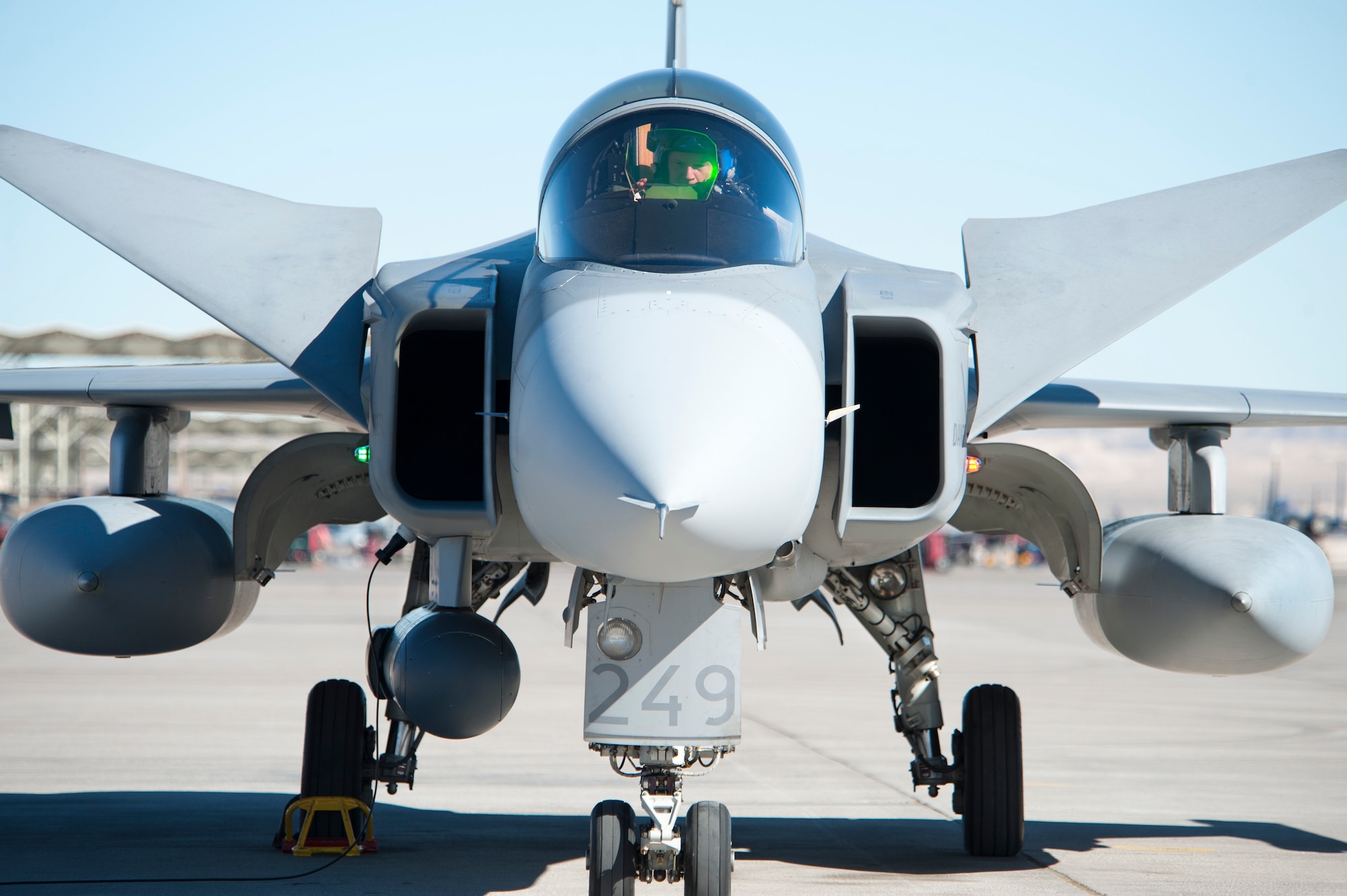 A Swedish Air Force pilot assigned to the 172nd Fighter Squadron, performs a pre-flight inspection on a Saab JAS-39C Gripen, Jan. 21, 2013 at Nellis Air Force Base, Nev. The Swedish AF participation in the U.S. Air Force's Red Flag exercise builds international air force cooperation, inter-operability and mutual support. (U.S. Air Force photo by Lawrence Crespo)