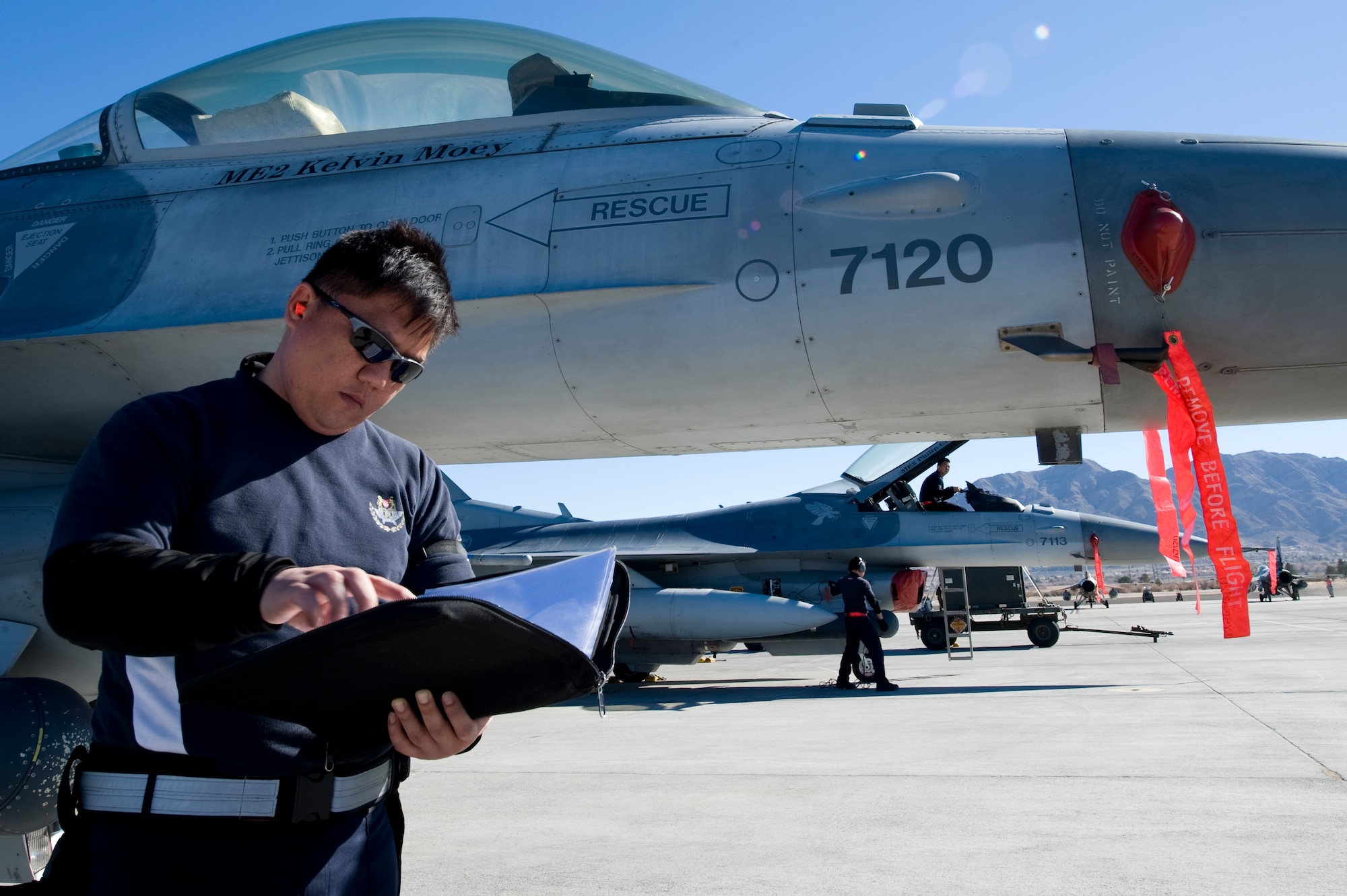 An Airman from the Republic of Singapore Air Force assigned to the 425th Fighter Squadron, Luke Air Force Base, Ariz., reads a pre-flight checklist during RED FLAG 13-2 Jan. 21, 2013, at Nellis Air Force Base, Nev. Red Flag provides a peacetime "battlefield" within which our combat air forces can  train. Inside this battlefield, aircrews train to fight together, survive together and win together. (U.S. Air Force photo by Staff Sgt. William P. Coleman)

  

