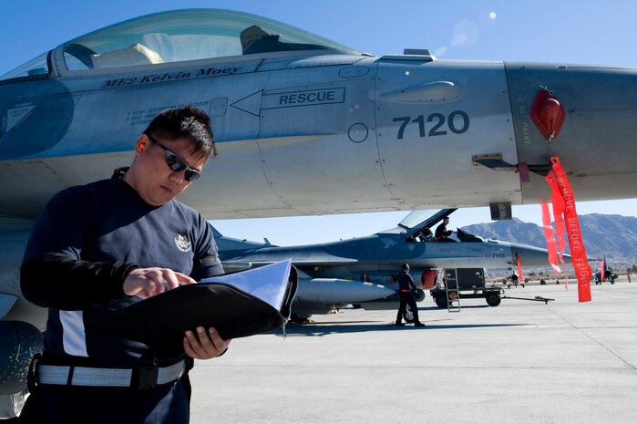 An Airman from the Republic of Singapore Air Force assigned to the 425th Fighter Squadron, Luke Air Force Base, Ariz., reads a pre-flight checklist during RED FLAG 13-2 Jan. 21, 2013, at Nellis Air Force Base, Nev. Red Flag provides a peacetime "battlefield" within which our combat air forces can  train. Inside this battlefield, aircrews train to fight together, survive together and win together. (U.S. Air Force photo by Staff Sgt. William P. Coleman)  