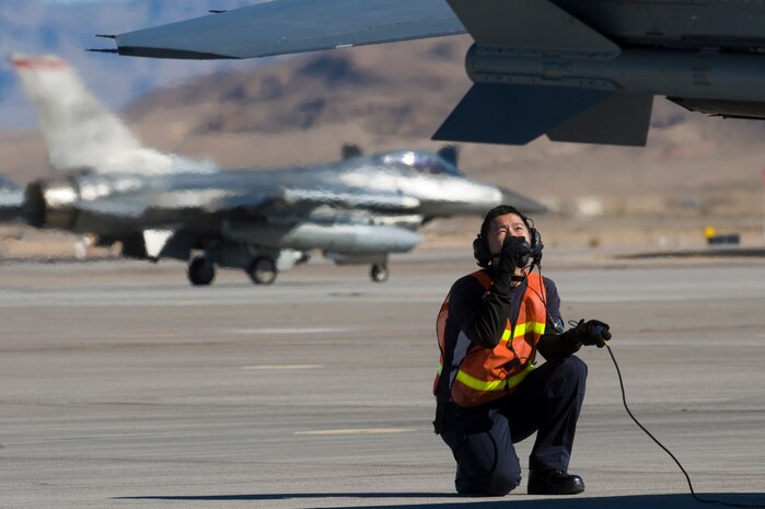 An Airman from the Republic of Singapore Air Force assigned to the 425th Fighter Squadron, Luke Air Force Base, Ariz., monitors the rudders and elevators of an F-16 Fighting Falcon during RED FLAG 13-2 Jan. 21, 2013, at Nellis Air Force Base, Nev. Because of limited airspace, the RSAF trains with counterparts overseas including Australia, America and France. (U.S. Air Force photo by Staff Sgt. William P. Coleman)  