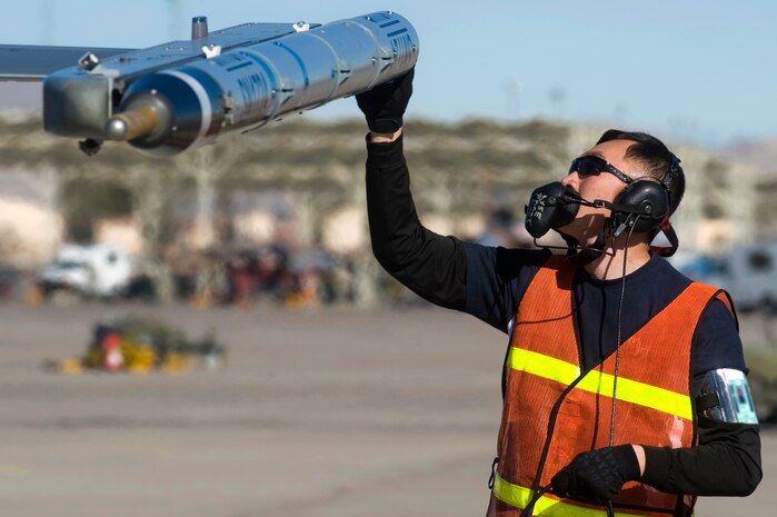 An Airman from the Republic of Singapore Air Force assigned to the 425th Fighter Squadron, Luke Air Force Base, Ariz., inspects an F-16 Fighting Falcon during RED FLAG 13-2 Jan. 21, 2013, at Nellis Air Force Base, Nev. Three years after Singapore gained independence on Aug. 9, 1965, the RSAF took flight as the Singapore Air Defense Command on Sept. 1, 1968. (U.S. Air Force photo by Staff Sgt. William P. Coleman)