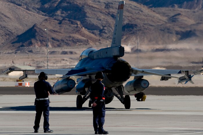 Airmen from the Republic of Singapore Air Force assigned to the 425th Fighter Squadron, Luke Air Force Base, Ariz., watch a Block 52 F-16 Fighting Falcon taxi toward the runway during RED FLAG 13-2 Jan. 21, 2013, at Nellis Air Force Base, Nev. Initially leasing Block 15 F-16s and training for day, conventional air-to-ground missions and within-visual-range aerial combat, the 425th now flies the Block 52 F-16 aircraft owned by Singapore and trains in all facets of modern airpower employment. (U.S. Air Force photo by Staff Sgt. William P. Coleman)  