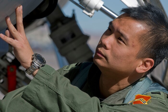 A pilot from the Republic of Singapore Air Force assigned to the 425th Fighter Squadron, Luke Air Force Base, Ariz., inspects an F-16 Fighting Falcon during RED FLAG 13-2 Jan. 21, 2013, at Nellis Air Force Base, Nev. Known as the Black Widows, the 425th FS is comprised of 150 RSAF personnel and 30 U.S. Air Force personnel. (U.S. Air Force photo by Staff Sgt. William P. Coleman)  