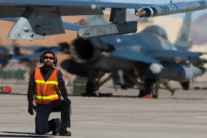 An Airman from the Republic of Singapore Air Force performs pre-flight checks for an F-16 Fighting Falcon during RED FLAG 13-2 Jan. 21, 2013, at Nellis Air Force Base, Nev. There are about 150 RSAF personnel assigned to the 425th Fighter Squadron and Aircraft Maintenance Unit at Luke Air Force Base, Ariz. (U.S. Air Force photo by Staff Sgt. William P. Coleman)  