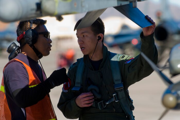 Airmen from the Republic of Singapore Air Force assigned to the 425th Fighter Squadron at Luke Air Force Base, Ariz., inspect an F-16 Fighting Falcon during RED FLAG 13-2 Jan. 21, 2013, at Nellis Air Force Base, Nev. During the two year assignment, they receive advanced tactics training, participate in RED FLAG, shoot live missiles at COMBAT ARCHER, and deploy to locations throughout the United States to participate in composite operations and dissimilar air combat exercises. (U.S. Air Force photo by Staff Sgt. William P. Coleman)  
