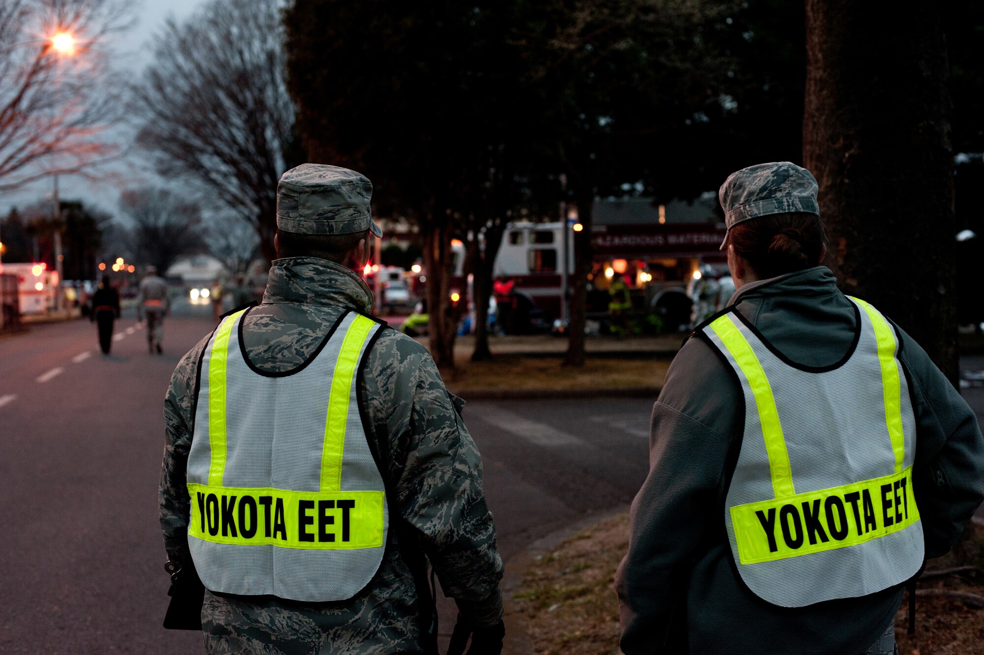 Yokota Exercise Evaluation Team members inspect on-scene first responders during an Emergency Management Exercise at Yokota Air Base, Japan, Jan. 22, 2013. Emergency Evaluation Team inspectors provide accurate after action reports to allow units to effectively evaluate how well they performed during an exercise and where they can improve. (U.S. Air Force photo by Senior Airman Cody H. Ramirez)