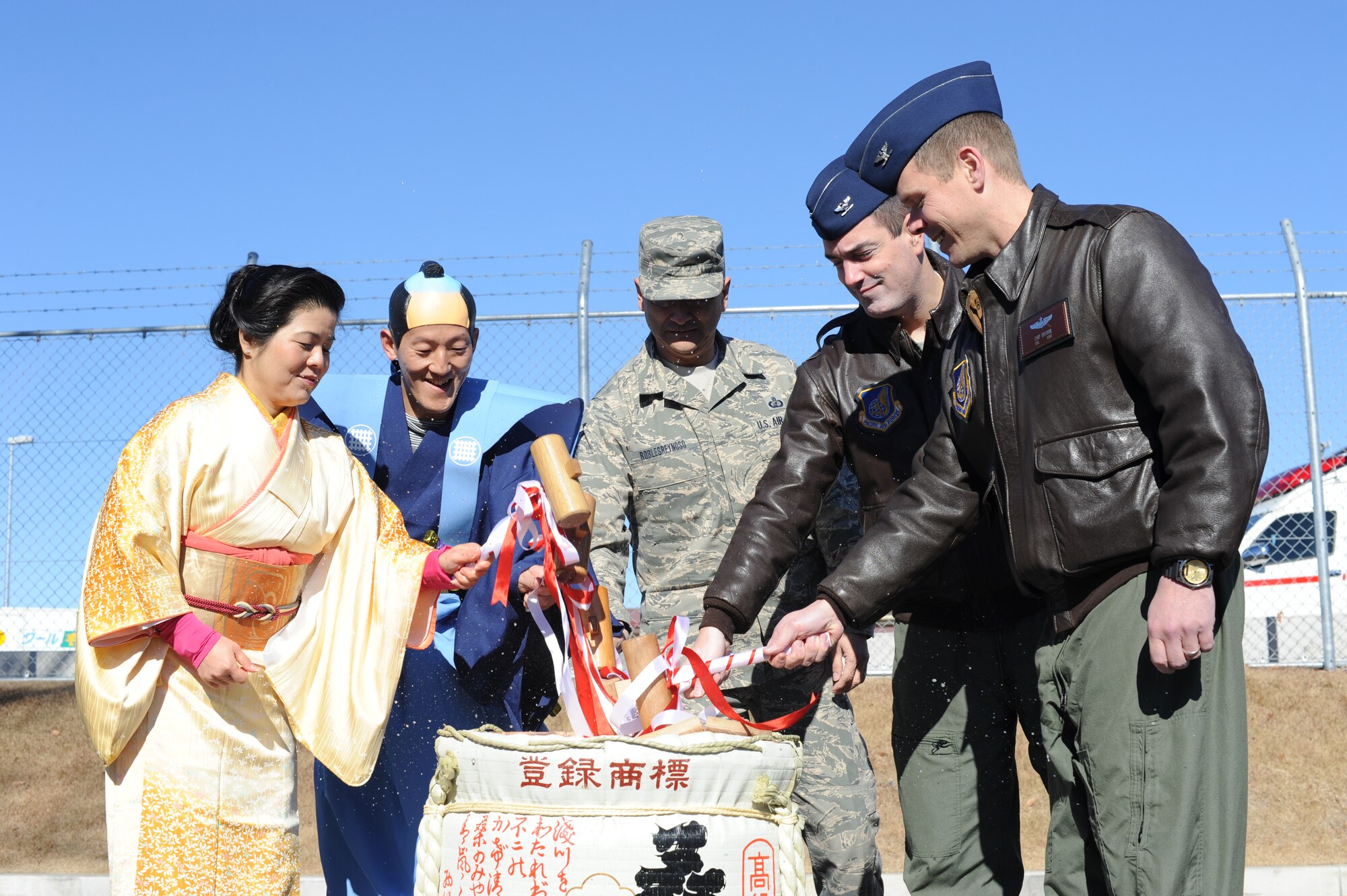 YOKOTA AIR BASE, Japan -- 374th Airlift Wing leadership and Japanese Welfare Association presidents smash a barrel of sake to ring in the New Year Jan. 18, 2013. The primary purpose of the JWA is to provide morale, welfare and recreation activities for Japanese employees and the Yokota community.  (U.S. Air Force photo by Airman 1st Class Meagan Schutter)  