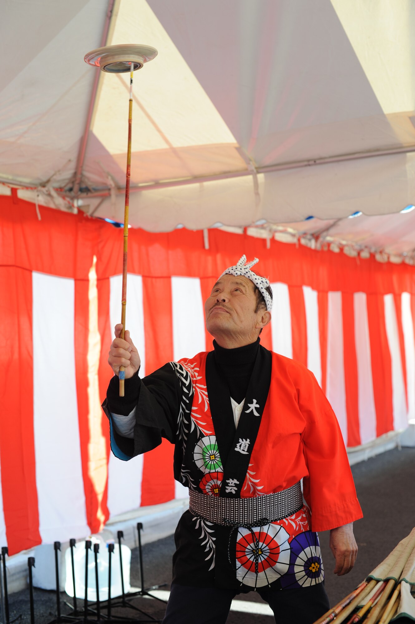 YOKOTA AIR BASE, Japan -- Sara-gei, a performer at the Japan Culture Day, takes a moment to show his plate spinning talents Jan. 18, 2013. Eight groups performed during the culture day festivities.  (U.S. Air Force photo by Airman 1st Class Meagan Schutter)  