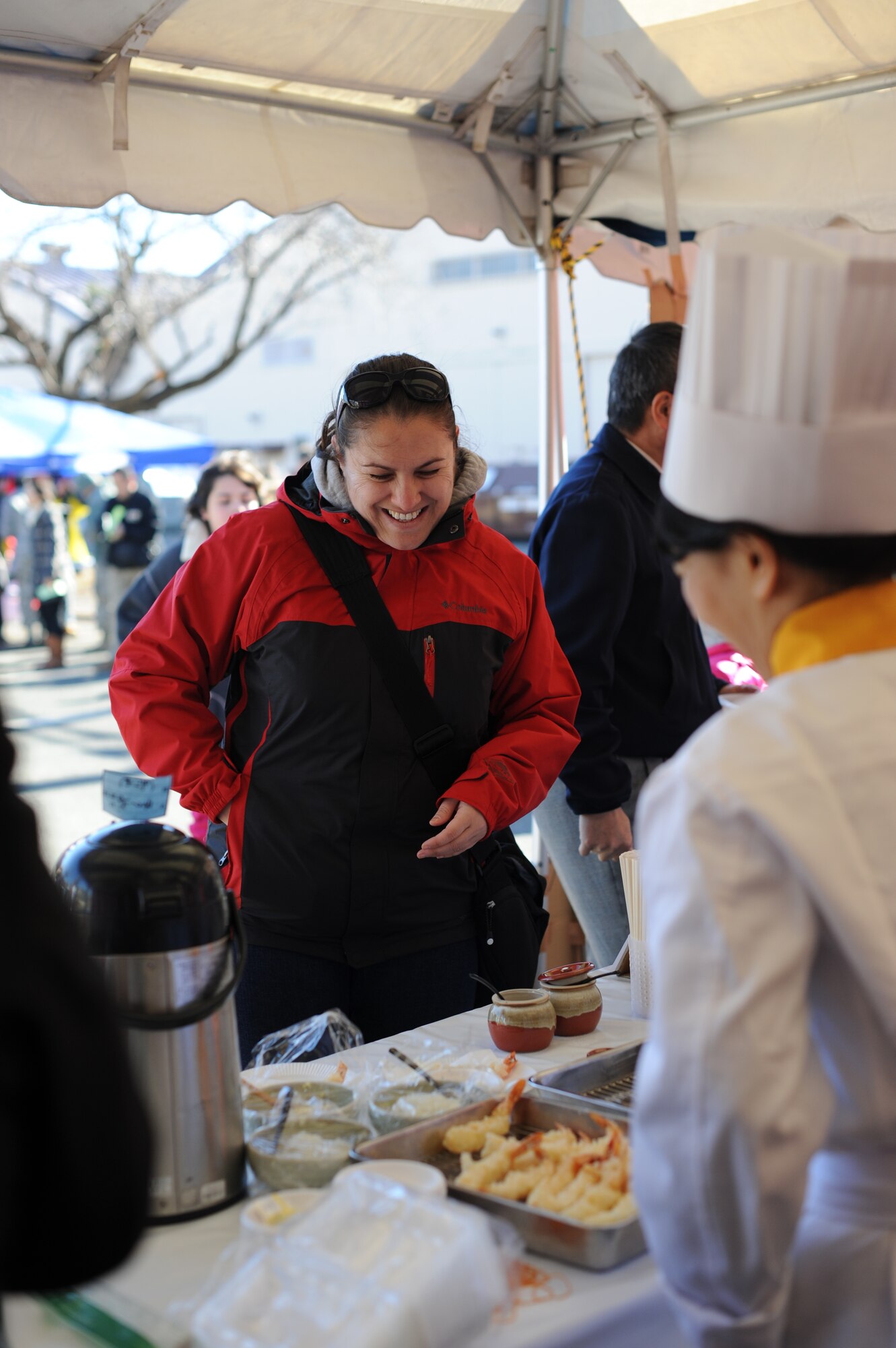 YOKOTA AIR BASE, Japan -- A resident of Yokota Air Base, Japan, purchases food from a vendor during the Japan Culture Day Jan. 18, 2013. During the event, the base community was able to sample a variety of Japanese food and watch performances.  (U.S. Air Force photo by Airman 1st Class Meagan Schutter)  