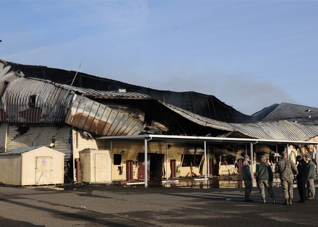 Leadership from the 9th Civil Engineer Squadron assess the damage from a fire at the squadron's main building at Beale Air Force Base, Calif., Jan. 22, 2013. The fire started at approximately 2:30 p.m. the day before, and firefighters from Beale and the surrounding community fought the fire throughout the night. (U.S. Air Force photo by Senior Airman Allen Pollard/Released)