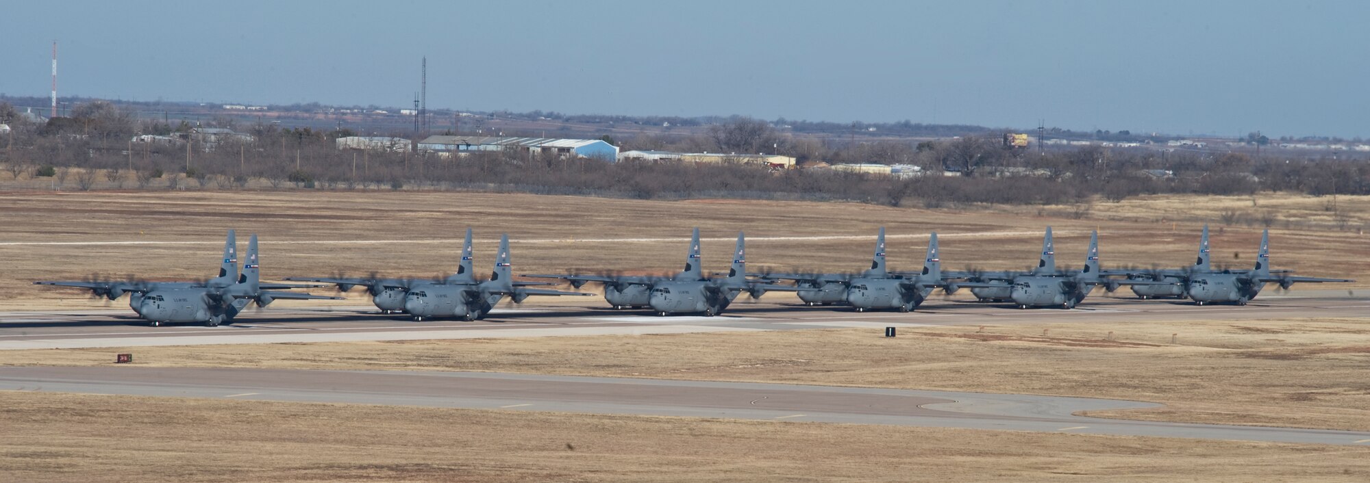 C-130Js assigned to the 317th Airlift Group taxi down the runway during an Operational Readiness Exercise Jan. 18, 2013, at Dyess Air Force Base, Texas. The purpose of the ORE was to validate the combat readiness of 317th AG units and their ability to execute assigned missions and tasks against a defined standard. Furthermore, six of the 12 C130Js continued on to Little Rock Air Force Base, Ark., to participate in a Joint Readiness Training Center exercise. (U.S. Air Force photo by Staff Sgt. Richard Ebensberger/Released)