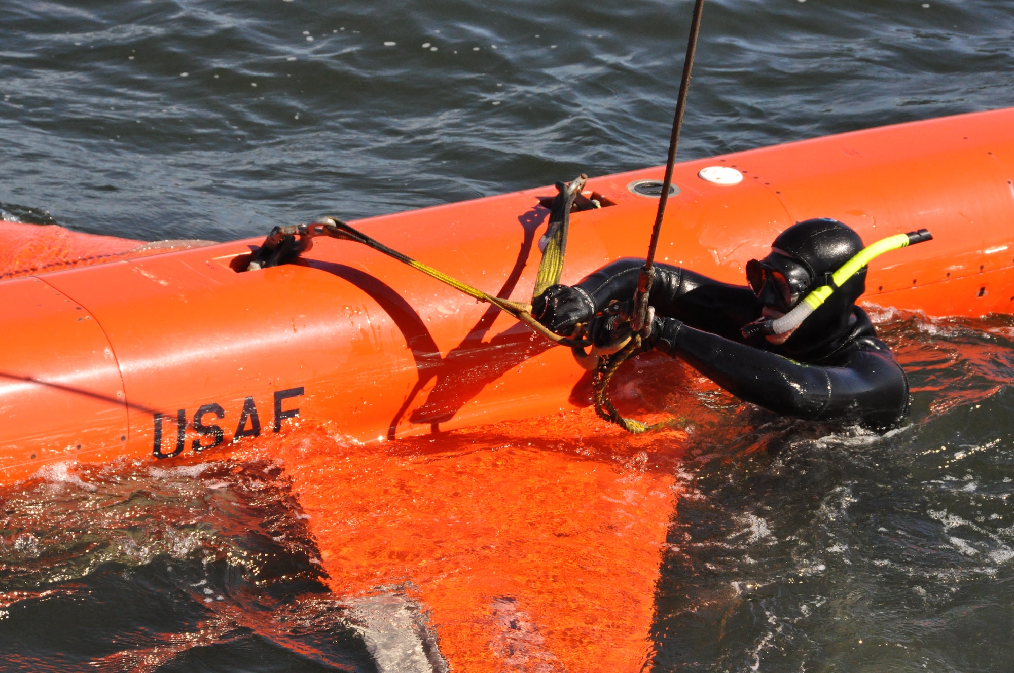 Mr. Chris Geradine, 82nd Aerial Targets Squadron Missile Retriever commercial diver, secures a BQM-167A drone to the crane during a training run. (U.S. Air Force photo by Staff Sgt. Rachelle Elsea)