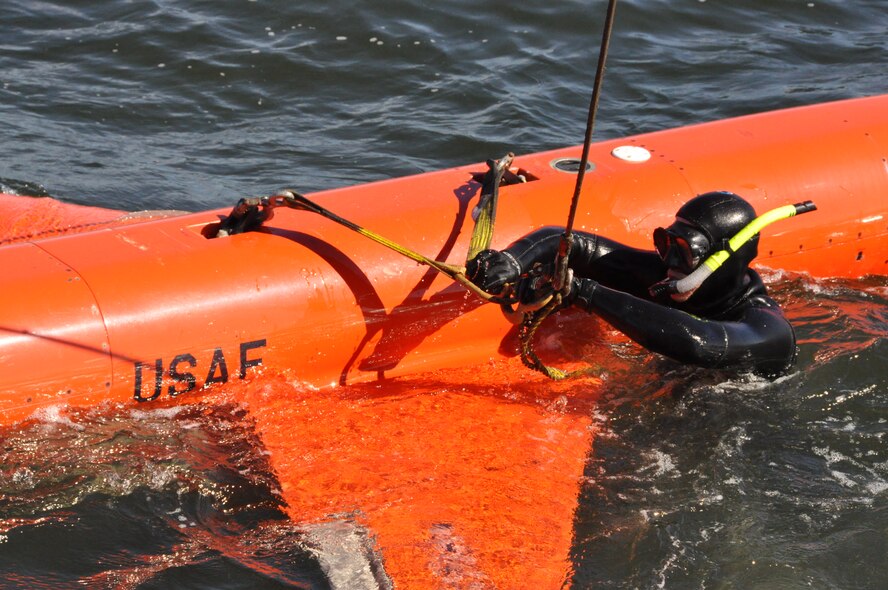 Chris Geradine, 82nd Aerial Targets Squadron Missile Retriever commercial diver, secures a BQM-167A drone to the crane during a training run. (U.S. Air Force photo by Staff Sgt. Rachelle Elsea) 
