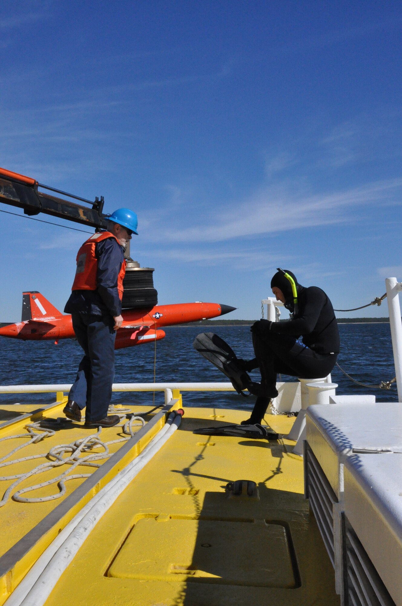 Mr. Ray Gallien and Mr. Chris Geradine, 82nd Aerial Targets Squadron Missile Retriever commercial divers, prepare to recover a BQM-167A drone during a training run. (U.S. Air Force photo by Staff Sgt. Rachelle Elsea)