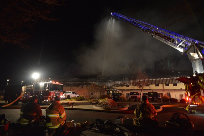 Firefighters and officials from Beale Air Force Base and other local fire departments coordinate to extinguish a structure fire at the 9th Civil Engineer building Jan. 21, 2013, on Beale Air Force Base, Calif. (U.S. Air Force photo by Airman 1st Class Drew Buchanan/Released)