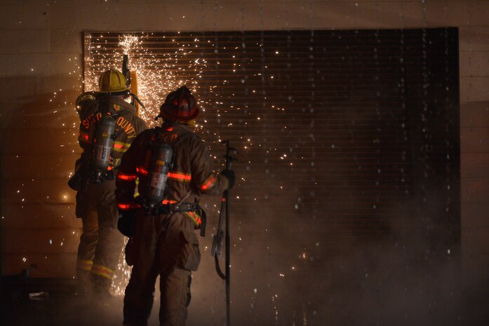 Firefighters work to extinguish a blaze at the 9th Civil Engineer Squadron building Jan. 21, 2013, at Beale Air Force Base, Calif. (U.S. Air Force photo by Airman 1st Class Drew Buchanan/Released)