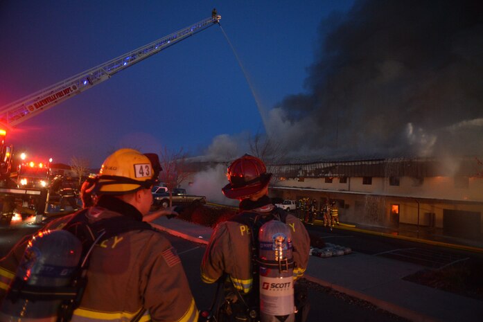 Firefighters work to extinguish a blaze at the 9th Civil Engineer Squadron building Jan. 21, 2013, at Beale Air Force Base, Calif. (U.S. Air Force photo by Airman 1st Class Drew Buchanan/Released)