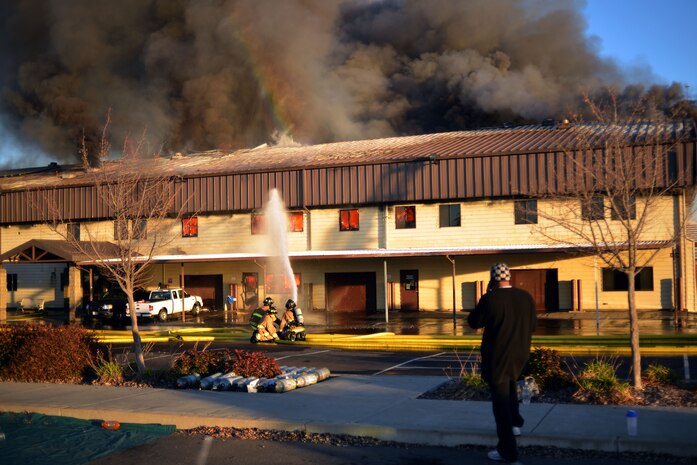 Firefighters work to extinguish a blaze at the 9th Civil Engineer Squadron building Jan. 21, 2013, at Beale Air Force Base, Calif. (U.S. Air Force photo by Airman 1st Class Drew Buchanan/Released)