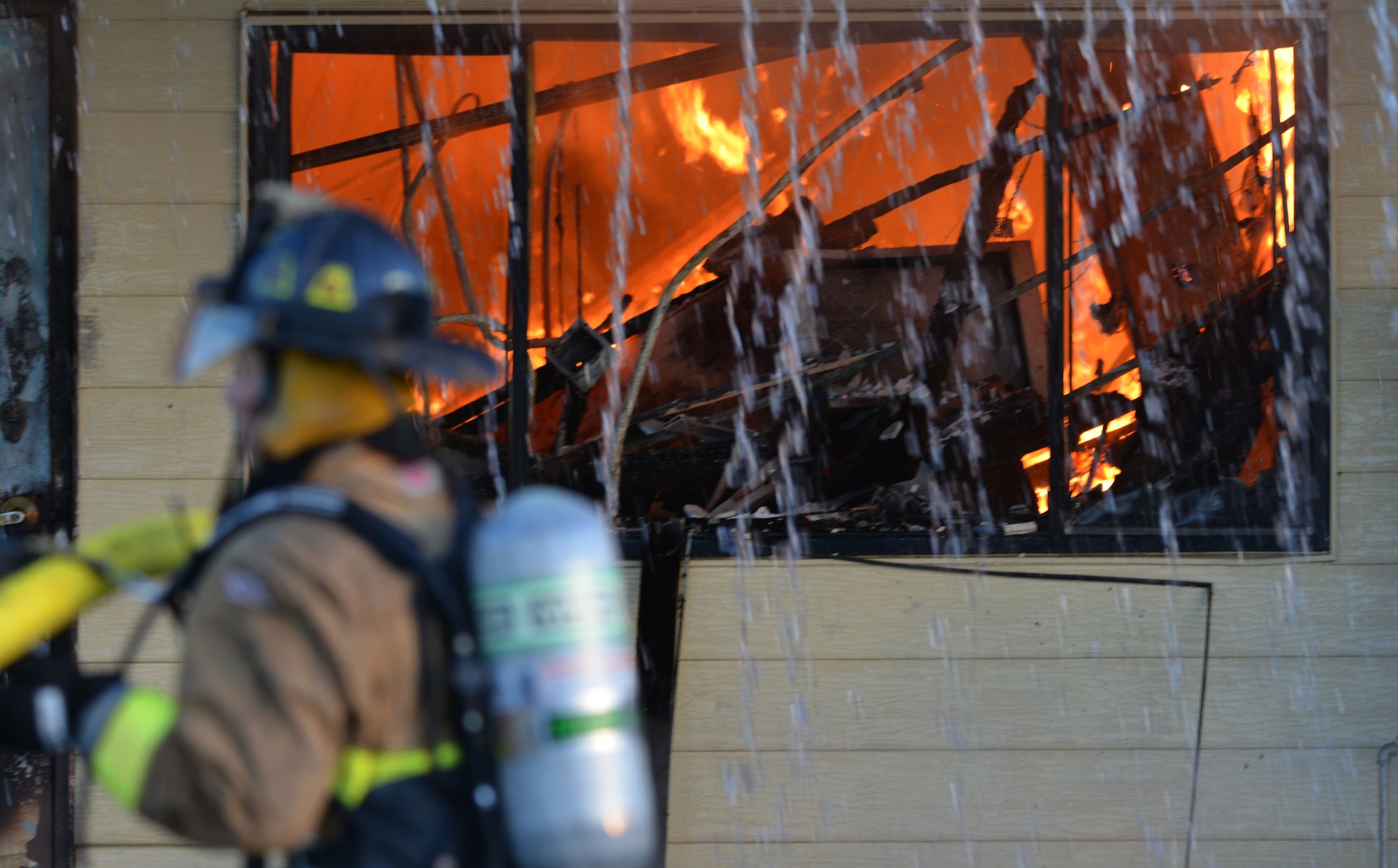 Firefighters from Beale Air Force Base and other local fire departments battle a structure fire at the 9th Civil Engineer building Jan. 21, 2013, at Beale Air Force Base, Calif. (U.S. Air Force photo by Airman 1st Class Drew Buchanan/Released)