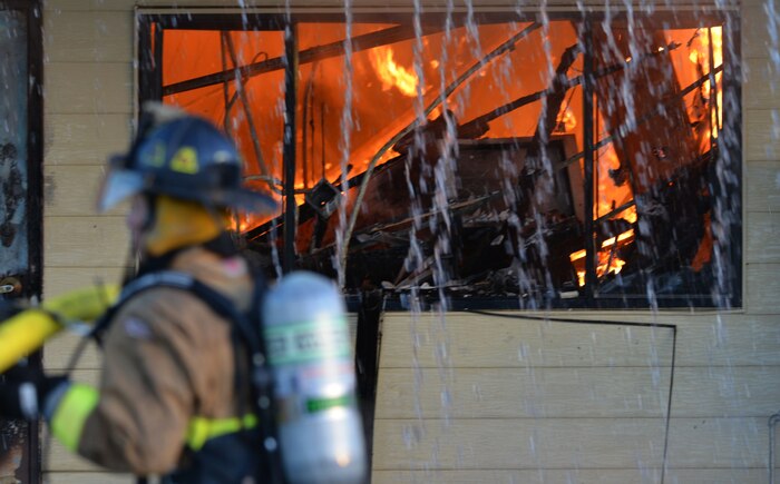 Firefighters from Beale Air Force Base and other local fire departments battle a structure fire at the 9th Civil Engineer building Jan. 21, 2013, at Beale Air Force Base, Calif. (U.S. Air Force photo by Airman 1st Class Drew Buchanan/Released)