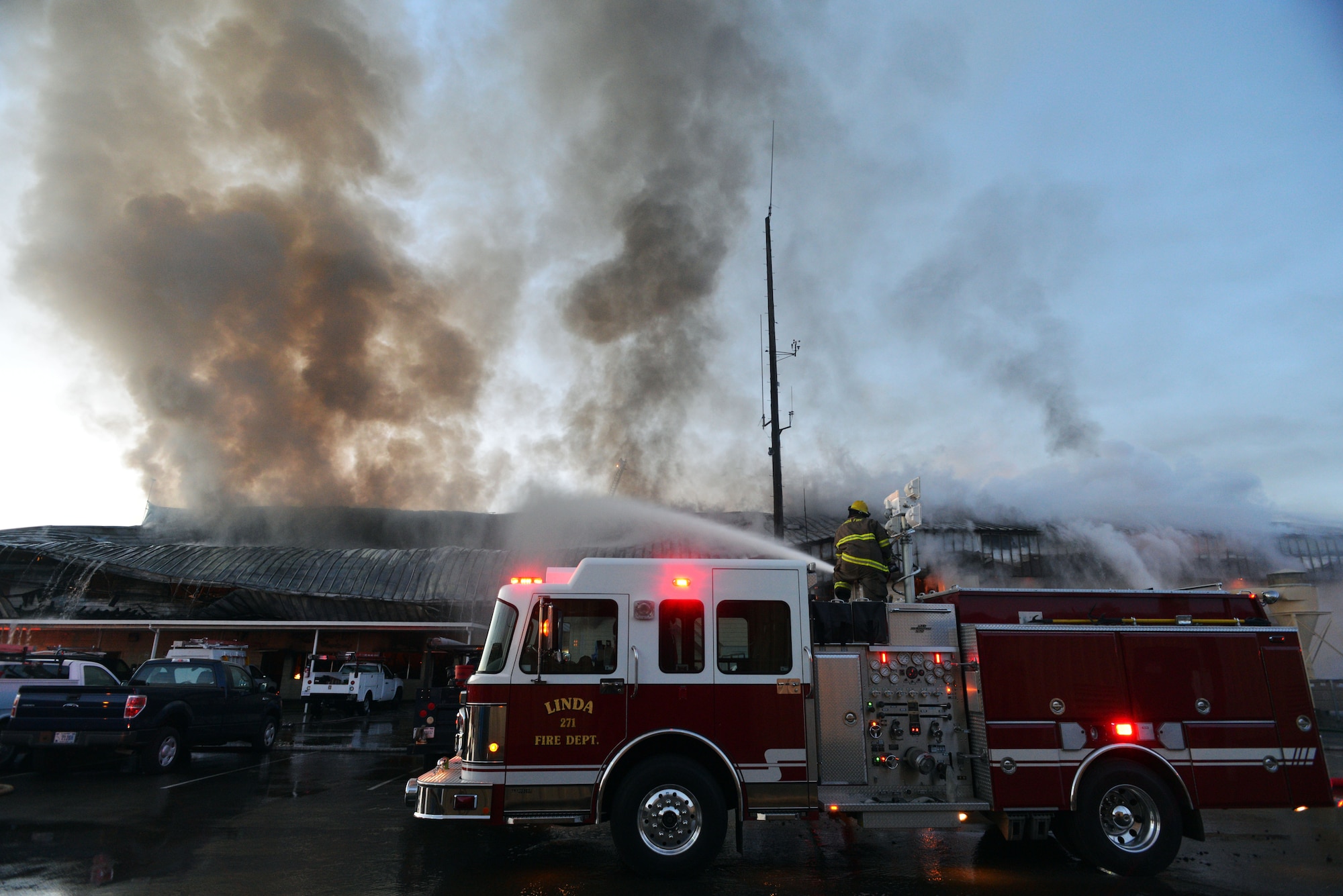 Firefighters from Beale Air Force Base and other local fire departments battle a structure fire at the 9th Civil Engineer buliding Jan. 21, 2013, at Beale Air Force Base, Calif. (U.S. Air Force photo by Airman 1st Class Drew Buchanan/Released)