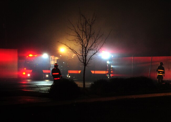 Light from emergency vehicles filters through smoke from a fire at the 9th Civil Engineer Squadron main building at Beale Air Force Base, Calif., Jan. 21, 2013. The fire started at approximately 2:30 p.m., and firefighters from Beale and the surrounding community fought the fire throughout the night. (U.S. Air Force photo by Senior Airman Shawn Nickel/Released)