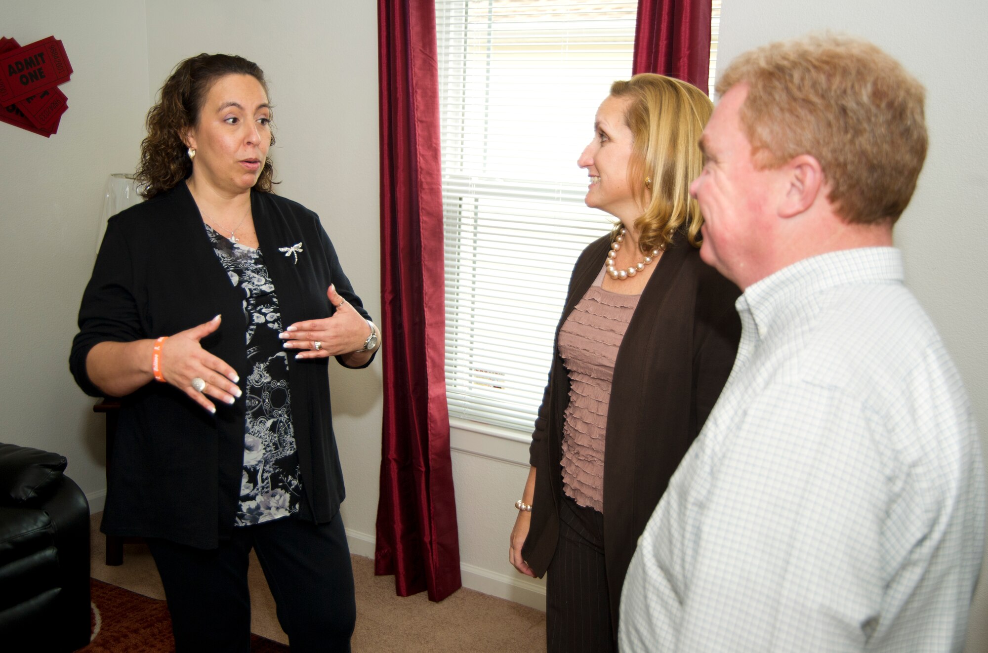 Lisa Battaglia, spouse of Marine Sgt. Maj. Bryan Battaglia, senior enlisted advisor to the Chairman of the Joint Chiefs of Staff, discusses the details of base housing arrangements with Valerie Mackin, spouse of Chief Master Sgt. Oscar Mackin, 2nd Air Force, and Brett Long, 81st Infrastructure Division, during a tour of the model home in West Falcon housing Jan. 16, 2013, at Keesler Air Force Base, Miss.  Sgt. Maj. Battaglia’s one-day visit allowed him the opportunity to acquaint himself with Keesler’s people, mission and contribution to the bigger military picture.  He also talked to enlisted Keesler members about the CJCS’ four priorities, his own key themes and his thoughts on bridging the basics and total force fitness.  (U.S. Air Force photo by Adam Bond)