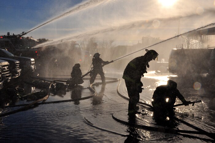 Firefighters work diligently to extinguish a fire at the 9th Civil Engineer Squadron building on Beale Air Force Base, Calif., Jan. 21, 2013.  Beale firefighters teamed with multiple fire departments from the surrounding area to extinguish the fire. (U.S. Air Force photo by Airman 1st Class Bobby Cummings/Released)
