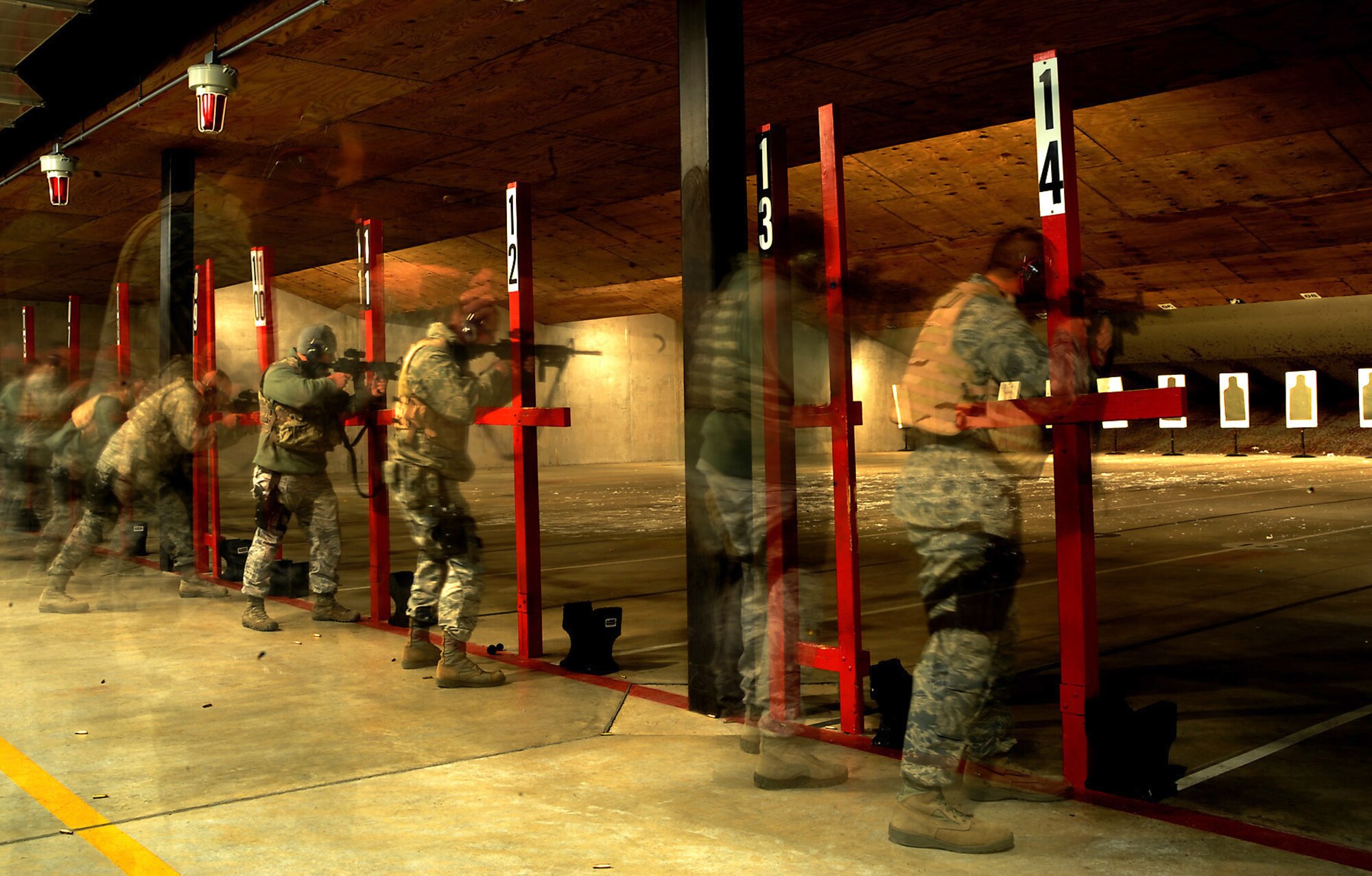 Security Forces members get into position to fire the M4 rifle during a night firing training session at Dover AFB, Del. (U.S. Air Force photo/ Staff Sgt. Liliana Moreno)