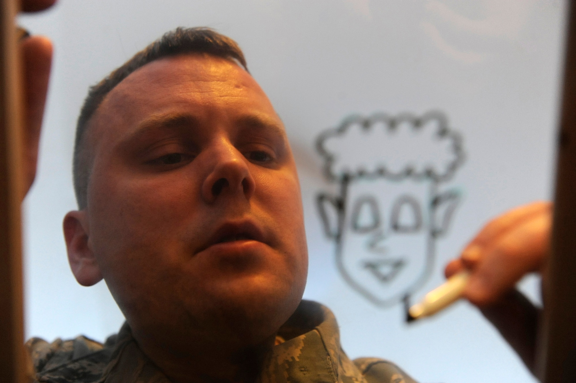 Air Force Staff Sgt. Benjamin Schneider works on his "Airman Artless" character in his home office on JBER Jan.14. Schneider is a cartoonist, creating the comical graphics as a hobby. His work has been published in the Okahoma Daily, the Aviano Air Base's the Vigileer in Italy, Kadena Air Base's Samurai Gate in Japan, U.S. Air Foces in Europe's Air Scoop Magazine, and the bi-weekly Crimson Sky in Korea. His work is also available on his website http://airmanartless.com. He is a training monitor for the 3rd Munitions Squadron. His hometown is Newscastle, Okla. (U.S. Air Force photo/Staff Sgt. Robert Barnett)