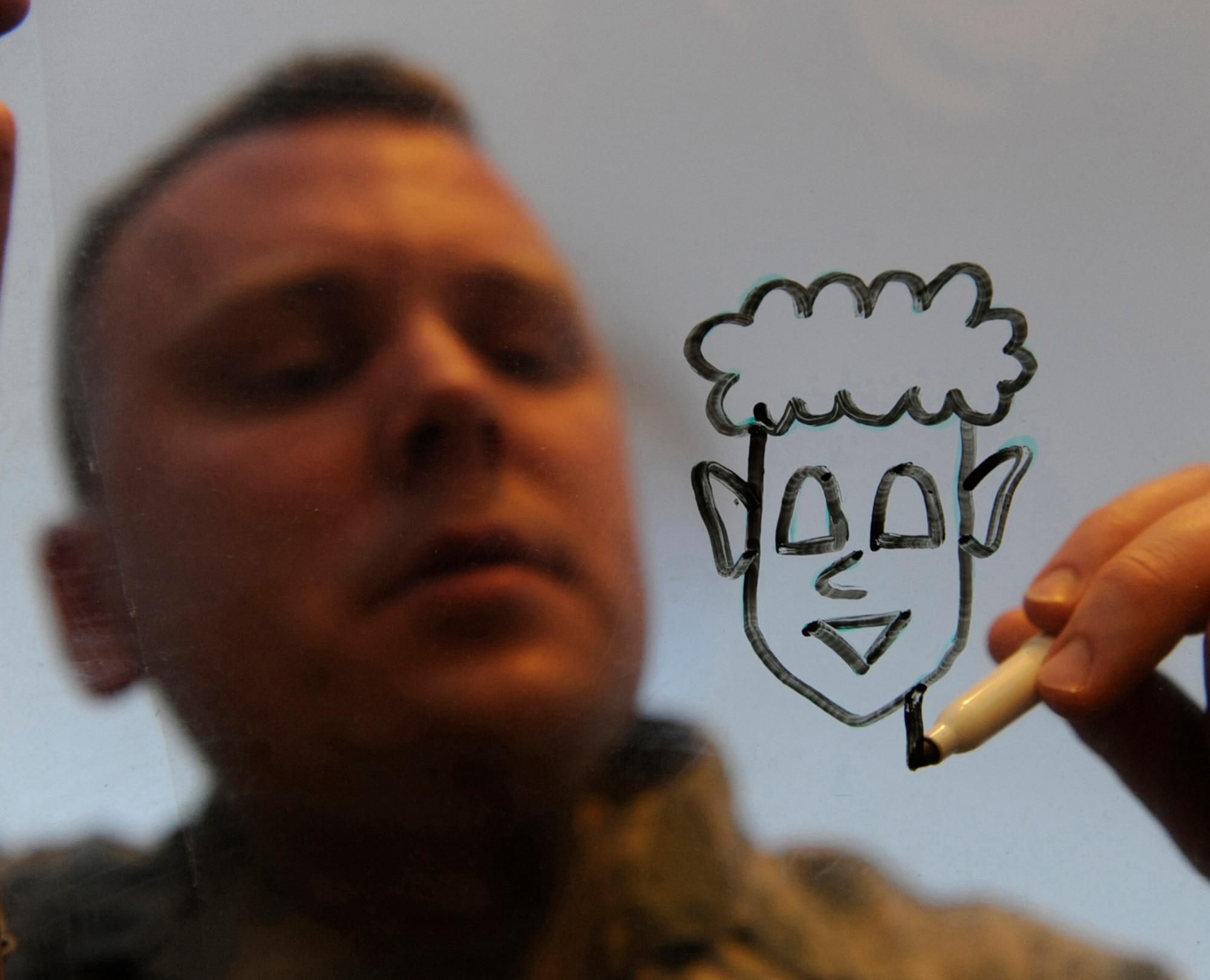 Air Force Staff Sgt. Benjamin Schneider works on his "Airman Artless" character in his home office on JBER Jan.14. Schneider is a cartoonist, creating the comical graphics as a hobby. His work has been published in the Okahoma Daily, the Aviano Air Base's the Vigileer in Italy, Kadena Air Base's Samurai Gate in Japan, U.S. Air Foces in Europe's Air Scoop Magazine, and the bi-weekly Crimson Sky in Korea. His work is also available on his website http://airmanartless.com. He is a training monitor for the 3rd Munitions Squadron. His hometown is Newscastle, Okla. (U.S. Air Force photo/Staff Sgt. Robert Barnett)