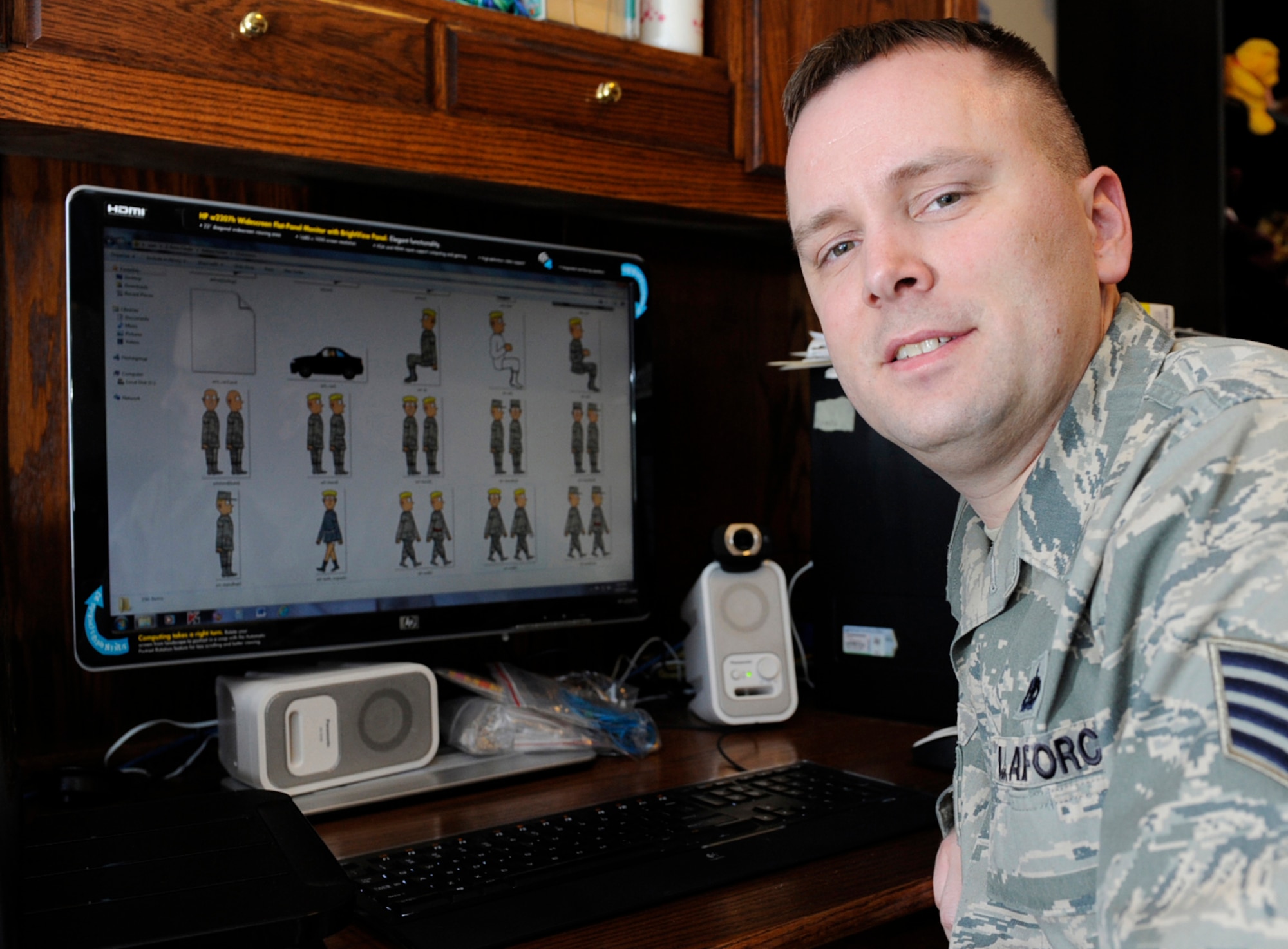 Air Force Staff Sgt. Benjamin Schneider shows off his archive of cartoon graphics in his home office on JBER Jan.14. Schneider is a cartoonist, creating the comical graphics as a hobby. His work has been published in the Okahoma Daily, the Aviano Air Base's the Vigileer in Italy, Kadena Air Base's Samurai Gate in Japan, U.S. Air Foces in Europe's Air Scoop Magazine, and the bi-weekly Crimson Sky in Korea. His work is also available on his website http://airmanartless.com. He is a training monitor for the 3rd Munitions Squadron. His hometown is Newscastle, Okla. (U.S. Air Force photo/Staff Sgt. Robert Barnett)