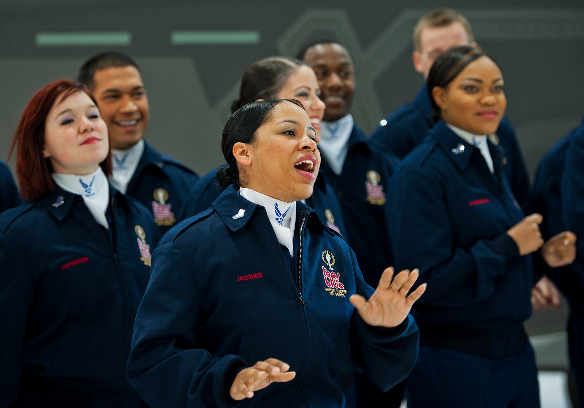 Senior Airman Joanell Jacques, a singer with Air Force Tops in Blue, belts out a song for members of the 33rd Fighter Wing Jan. 22 at Eglin Air Force Base, Fla.  The group got an up-close view of an F-35A Lightning II while visiting the shop of one of their own, Tech. Sgt. Michael Menges, a wing member who's now a lighting and sound technician for TIB.  This was a short stop before their performance at the Emerald Coast Conference Center in Fort Walton Beach, Fla.  (U.S. Air Force photo/Samuel King Jr.)