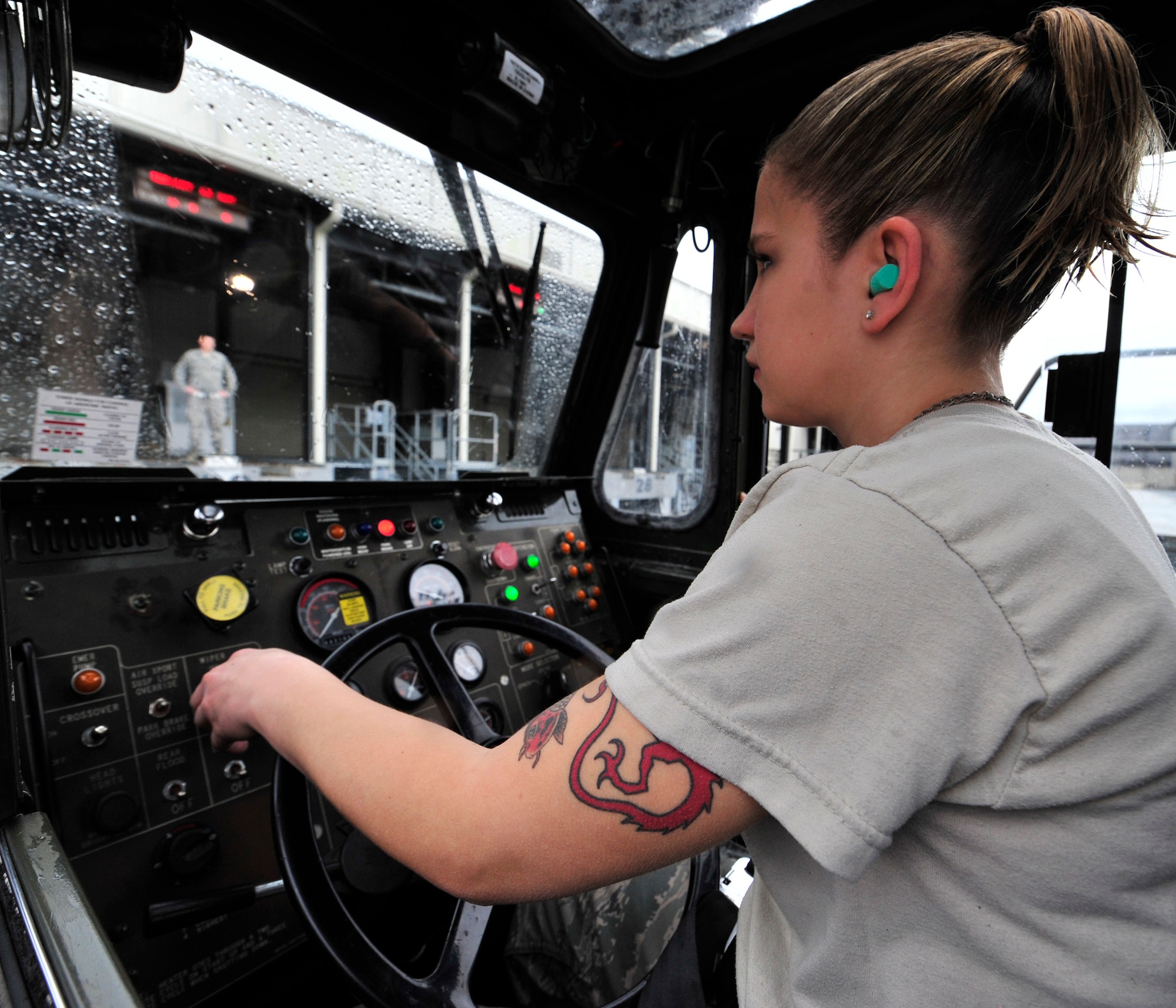 Airman 1st Class Sarah Lipfird, 436th Aerial Port Squadron, drives a 60K Tunner Loader to one of the loading docks as Airman 1st Class Benjamin Hann guides Jan. 14, 2013, at Dover Air Force Base, Del. The 436th APS recently won the Air Mobility Command Large Terminal Unit of the Year award. (U.S. Air Force photo by Tech. Sgt. Chuck Walker)