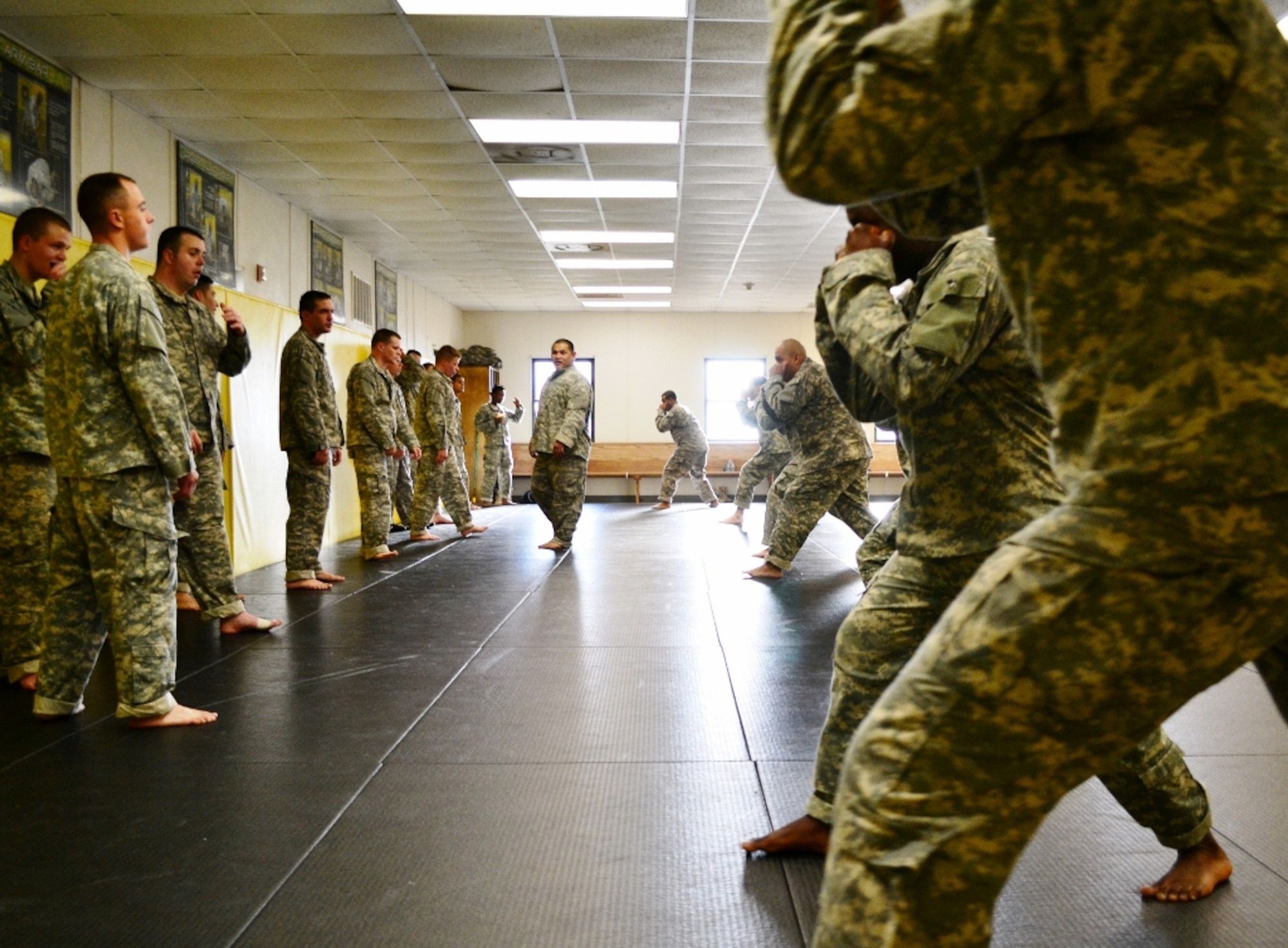 U.S. Army  Staff Sgt. Jedadiah Eustaquio, a level-two combatives instructor assigned to the 368th Seaport Operations Company, 10th Transportation Battalion, 7th Sustainment Brigade, supervises basic fighting stance drills during day three of the Level-One 40-hour Modern Combatives Program at the Fort Eustis Combatives Academy at Fort Eustis, Va., Jan 9, 2012. Eustaquio said the combatives program helps Soldiers develop confidence in themselves while becoming better-trained, “more competent warriors.” (U.S. Army photo by Sgt. Edwin Rodriguez/Released)