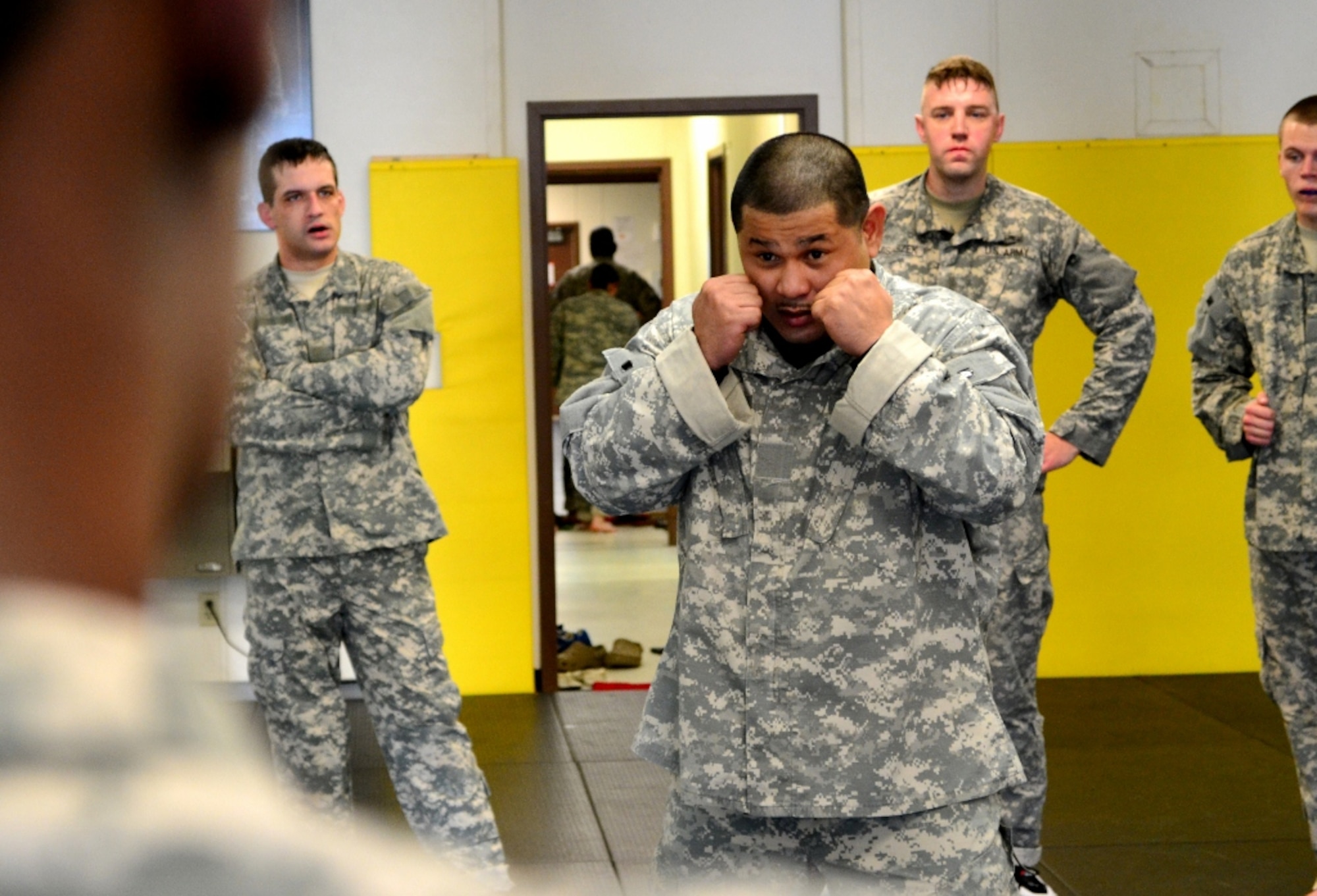 U.S. Army Staff Sgt. Jedadiah Eustaquio, a level-two combatives instructor assigned to the 368th Seaport Operations Company, 10th Transportation Battalion, 7th Sustainment Brigade, shows the basic level-one fighting stance during day three of the 40-hour Modern Combatives Program at the Fort Eustis Combatives Academy at Fort Eustis, Va., Jan 9, 2012. The three basic options specific for combatants are to disengage with the enemy, gain a controlling position and finish the fight. (U.S. Army photo by Sgt. Edwin Rodriguez/Released)