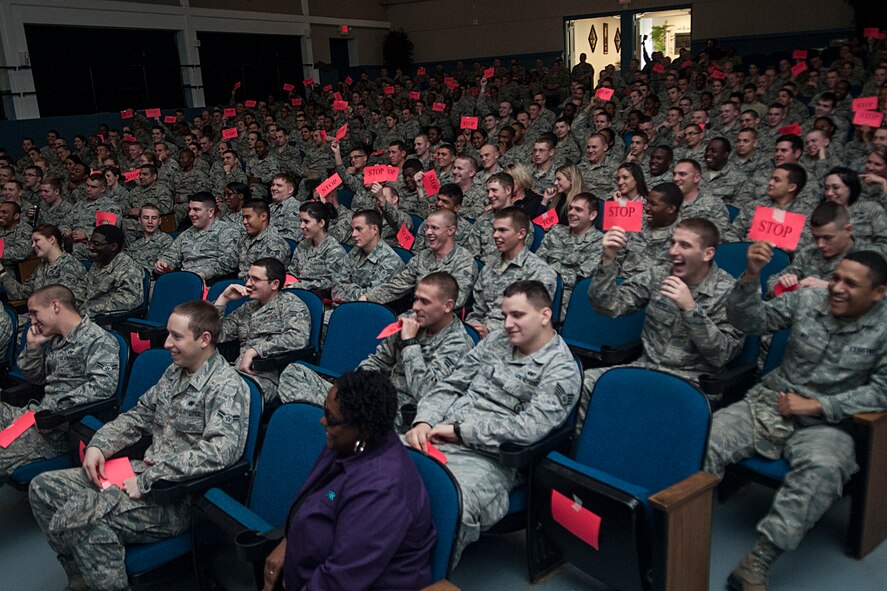 Members of Team Moody hold up “stop” signs during a Sex Signals presentation as part of Wingman Day Jan. 18, 2013, at Moody Air Force Base, Ga. The presentation involved outside participation as audience members held up signs in reaction to various situations. (U.S. Air Force photo by Airman Paul Francis/Released) 