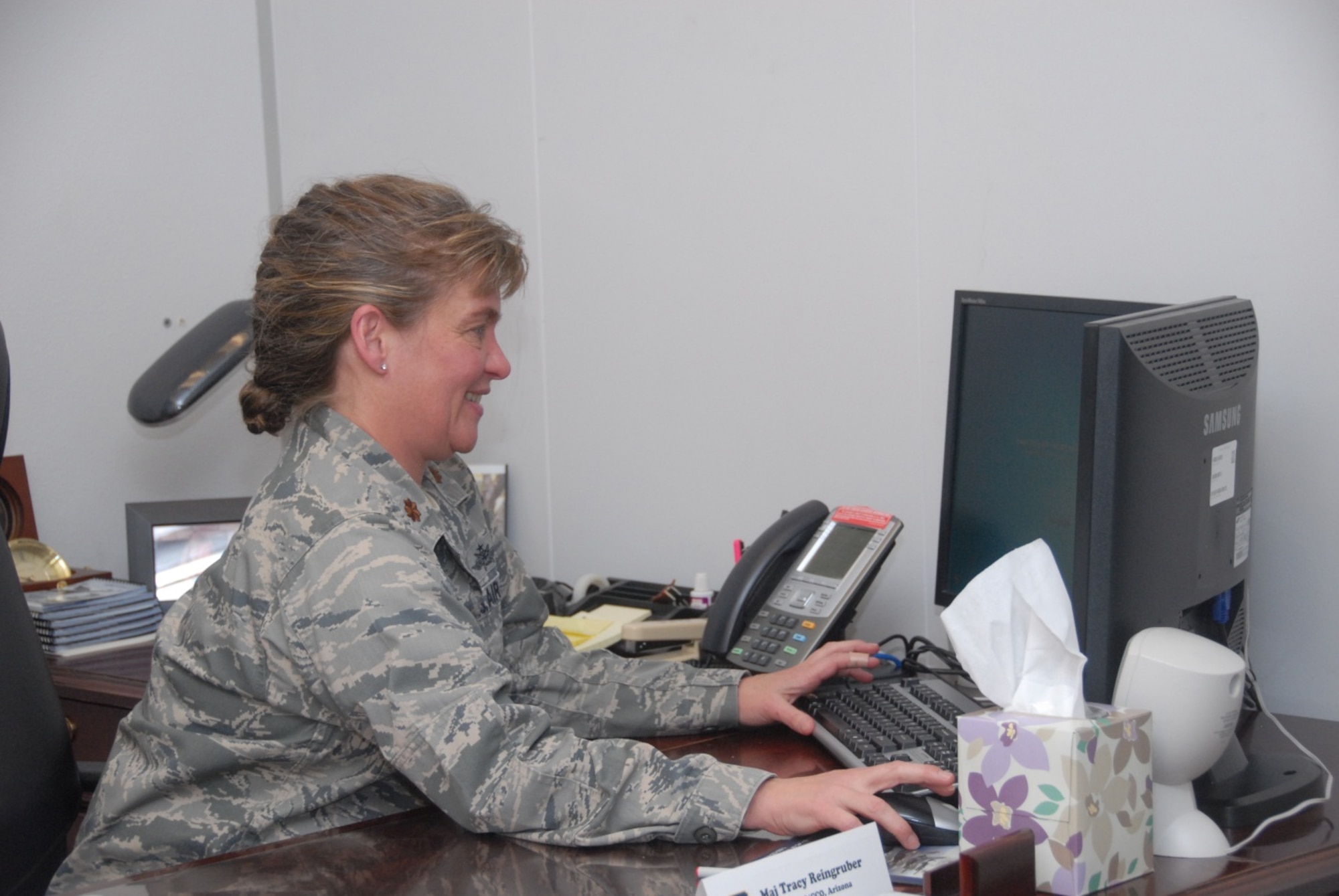 Maj. Tracy Reingruber, commander of the 162nd Communications Flight, performs routine command functions during January’s Unit Training Assembly. Maj. Reingruber recently attained a Master’s of Military Operational Art and Science from the Air Command and Staff College, and was selected as the Officer of the Quarter for the Mission Support Group. (U.S. Air Force photo/Staff Sgt. Heather Davis)